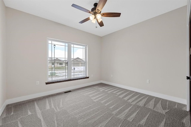 spare room featuring carpet flooring and ceiling fan