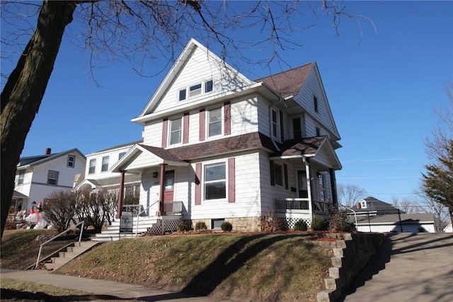 view of front facade featuring cooling unit, a porch, and a front lawn