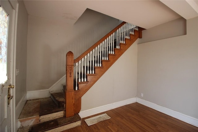 stairs with hardwood / wood-style floors and plenty of natural light