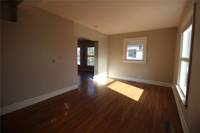 unfurnished room featuring dark wood-type flooring