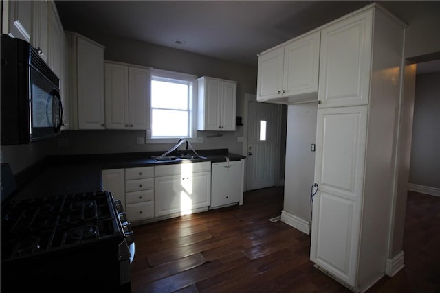 kitchen with black appliances, white cabinets, sink, and dark wood-type flooring