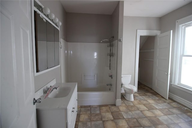 full bathroom featuring toilet, plenty of natural light, vanity, and tub / shower combination