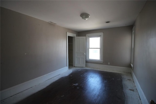 spare room with wood-type flooring