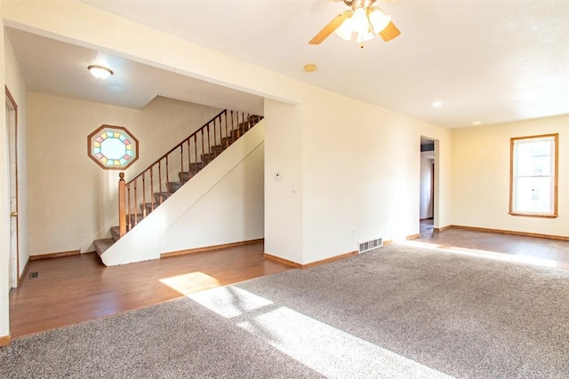 carpeted spare room featuring ceiling fan