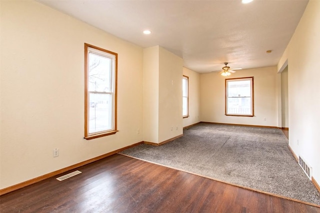 empty room with hardwood / wood-style flooring and ceiling fan