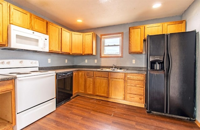 kitchen featuring sink, black appliances, and dark wood-type flooring