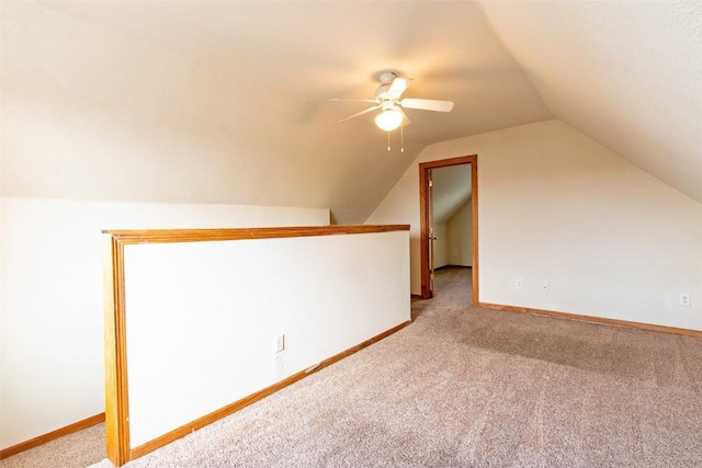 bonus room with vaulted ceiling, ceiling fan, and carpet