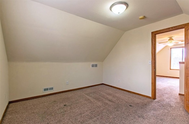 bonus room featuring ceiling fan, light carpet, and lofted ceiling