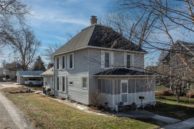 view of property exterior with a lawn and a sunroom