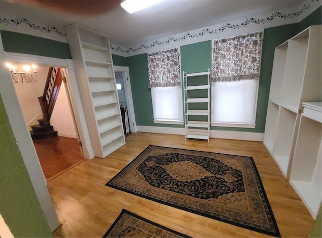 interior space featuring an inviting chandelier and light hardwood / wood-style floors