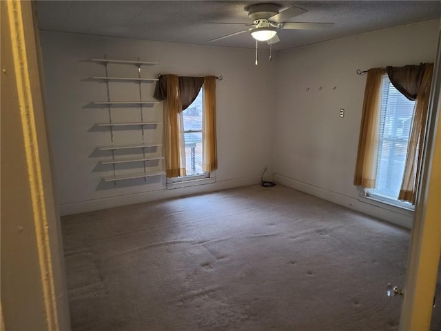 empty room with ceiling fan and a textured ceiling