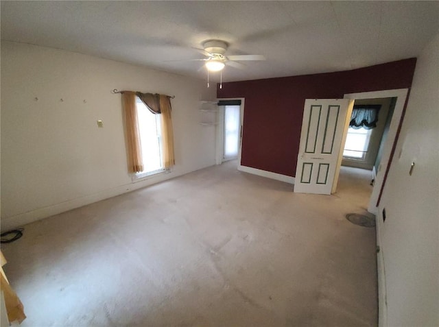 spare room with light colored carpet and ceiling fan