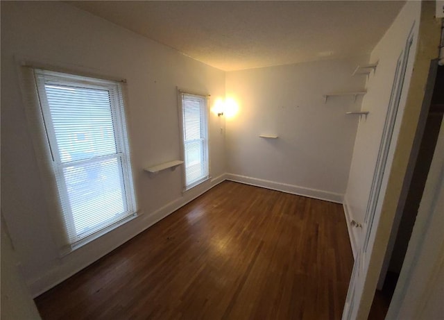 unfurnished room featuring dark wood-type flooring