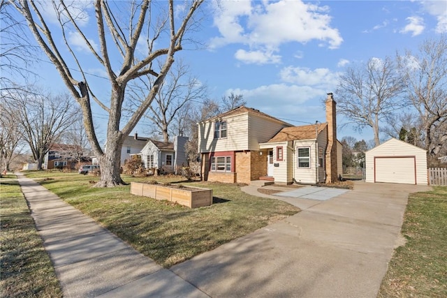 view of front of home featuring an outbuilding, a front yard, and a garage