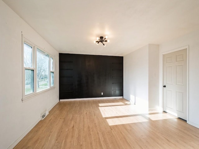 spare room with light wood-type flooring