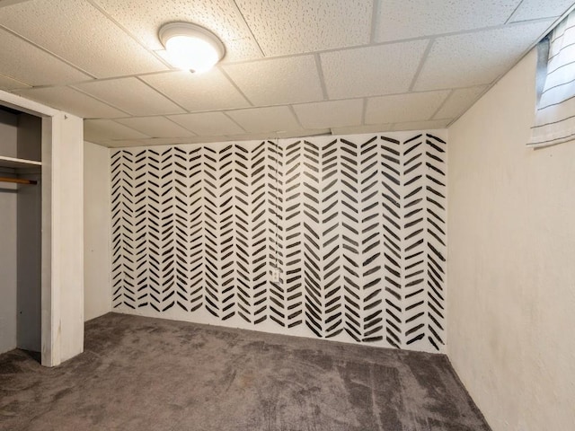 basement featuring carpet flooring and a drop ceiling