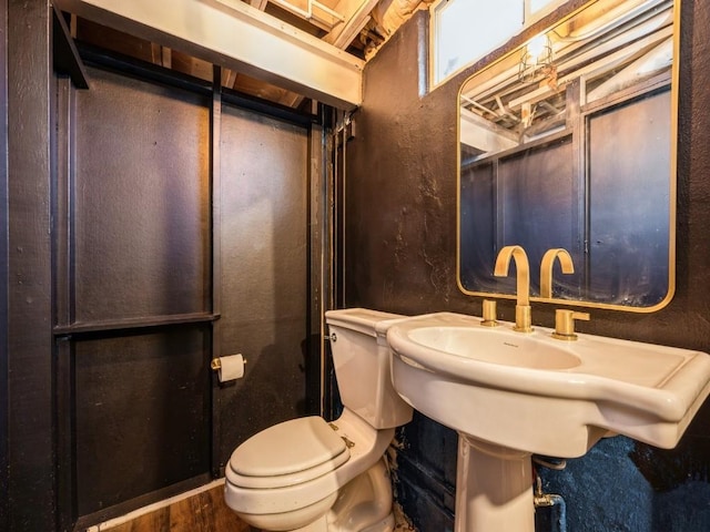 bathroom featuring toilet and wood-type flooring