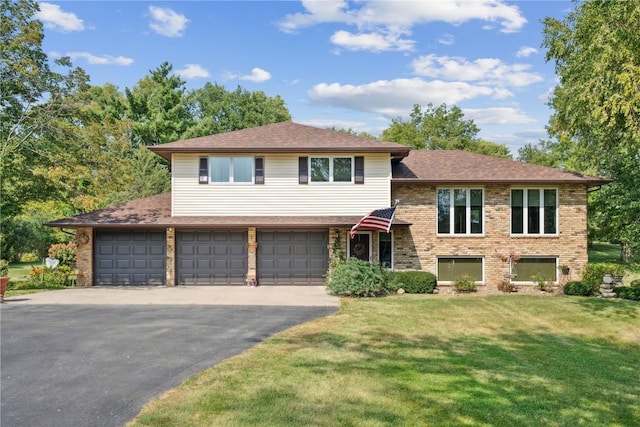 tri-level home with a front yard and a garage