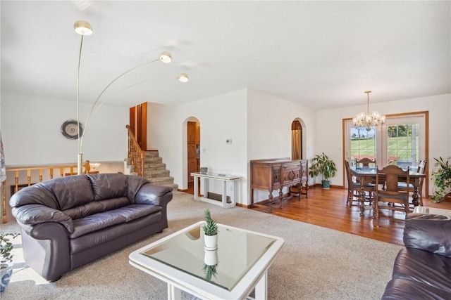 living room with wood-type flooring and an inviting chandelier