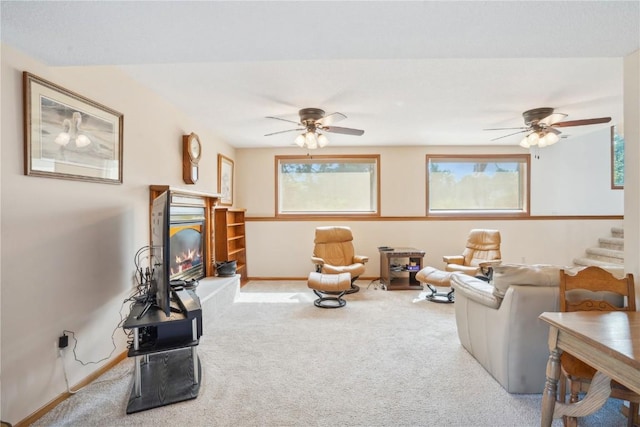 carpeted living room with ceiling fan