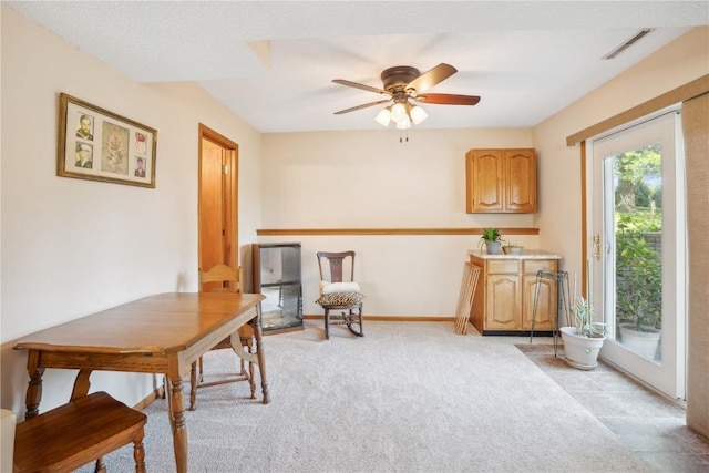 living area with light carpet and ceiling fan