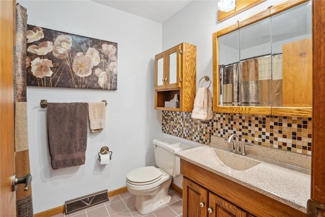 bathroom with tile patterned flooring, decorative backsplash, toilet, and vanity