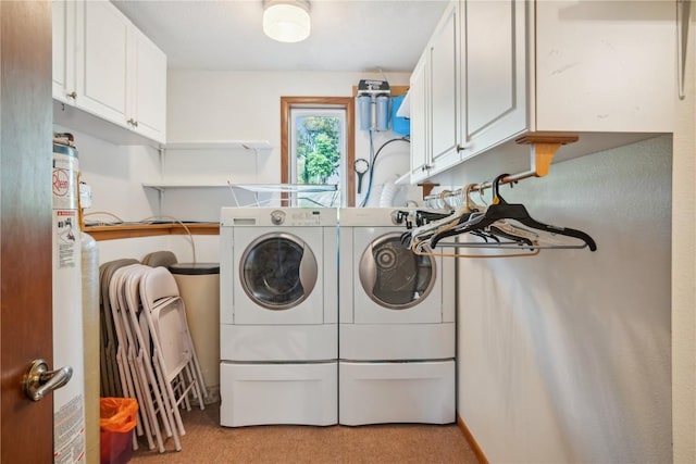 clothes washing area featuring light colored carpet, cabinets, and independent washer and dryer