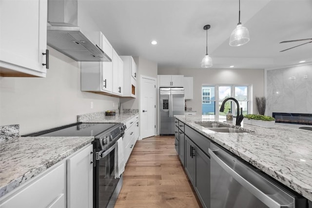 kitchen featuring ventilation hood, white cabinets, sink, and appliances with stainless steel finishes