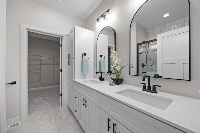 bathroom with vanity and a shower with shower door