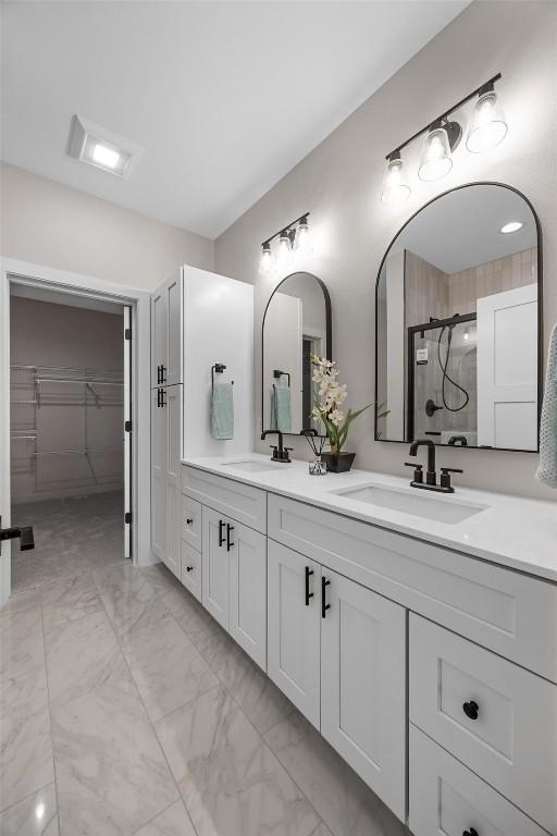 bathroom with vanity and a shower with shower door