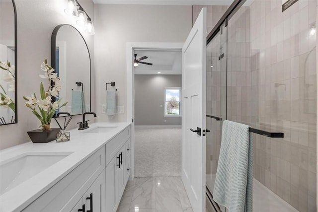 bathroom with vanity, ceiling fan, and a shower with shower door