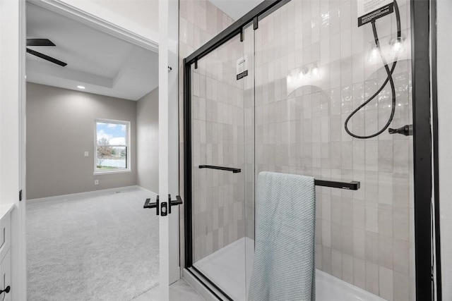 bathroom with ceiling fan and a shower with shower door