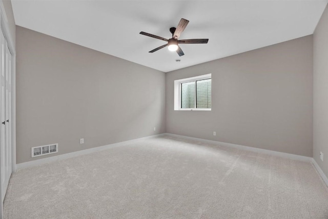 spare room with ceiling fan and carpet floors