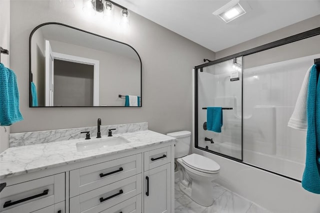 full bathroom featuring vanity, enclosed tub / shower combo, and toilet