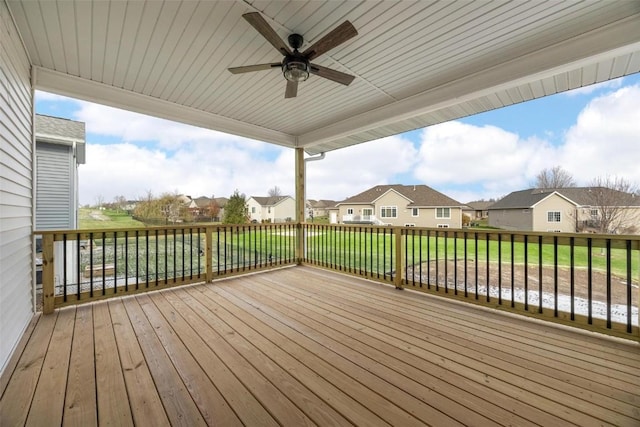 deck featuring a yard and ceiling fan