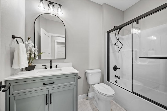 1596 Connection Ave, Marion, IA 52302 - bathroom with marble look tile flooring, vanity, toilet, baseboards, and shower / bath combination with glass door