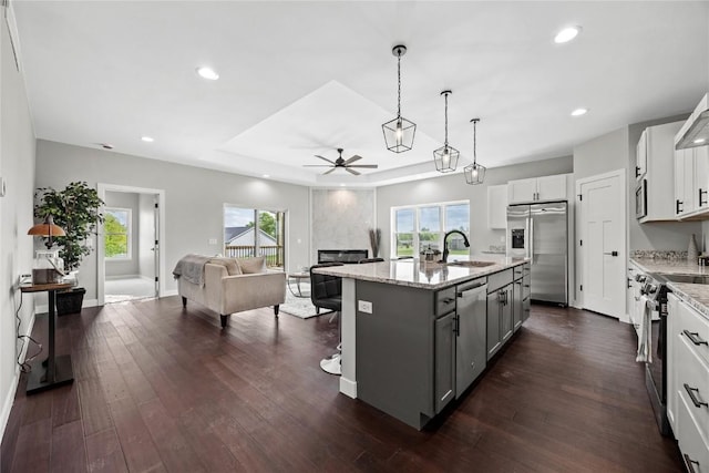 1596 Connection Ave, Marion, IA 52302 - kitchen with appliances with stainless steel finishes, ceiling fan, open floor plan, a center island with sink, and gray cabinetry
