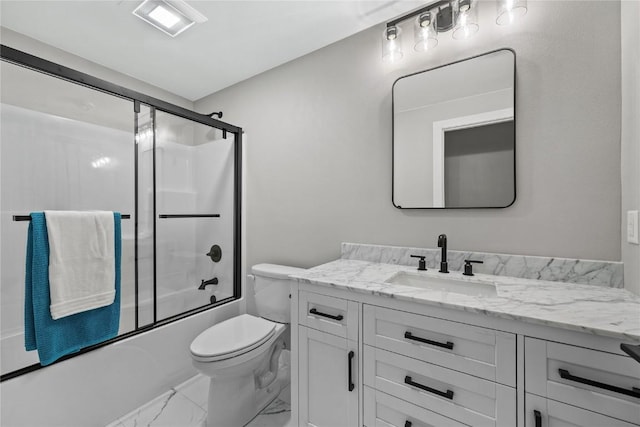 1596 Connection Ave, Marion, IA 52302 - full bath with marble look tiles, vanity, toilet, and combined bath / shower with glass door