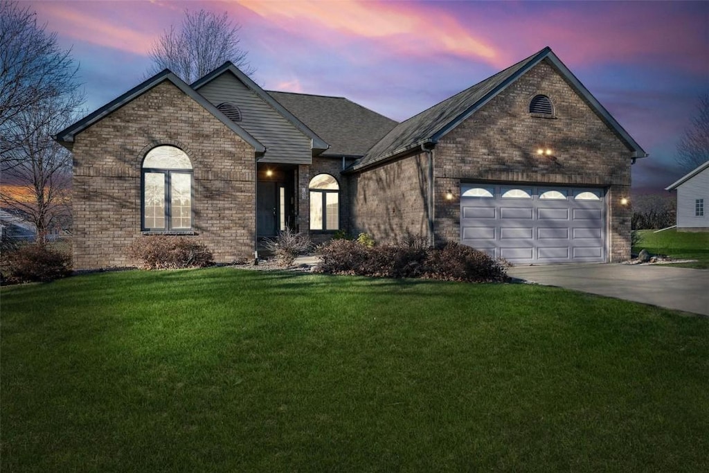 view of front of house featuring a yard and a garage