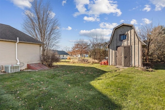 view of yard with central AC unit and a storage unit