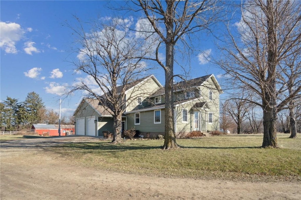 view of front of house with a front yard and a garage