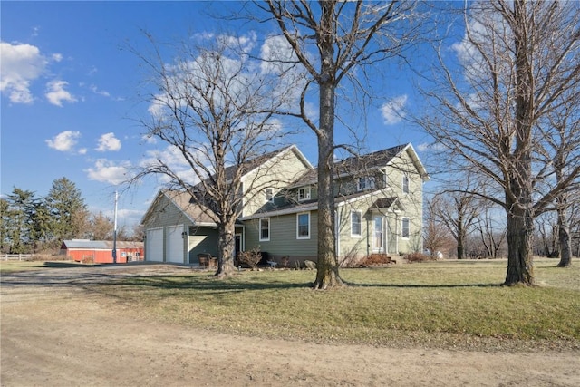 view of front of house with a front yard and a garage