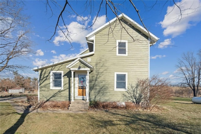 view of property featuring a front lawn