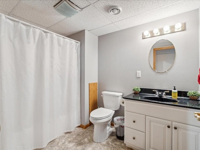 bathroom featuring vanity, a paneled ceiling, and toilet