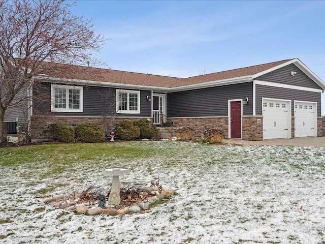 ranch-style house featuring a lawn and a garage