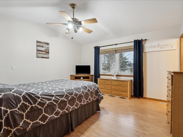 bedroom with light wood-type flooring, ceiling fan, and lofted ceiling