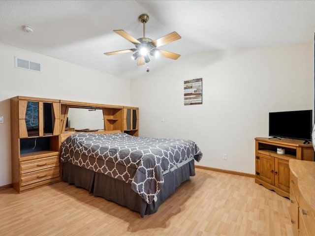 bedroom with ceiling fan, light wood-type flooring, and lofted ceiling