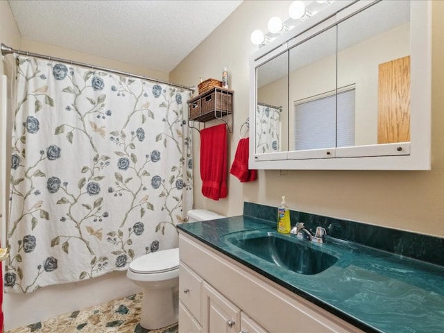 bathroom with a textured ceiling, vanity, and toilet