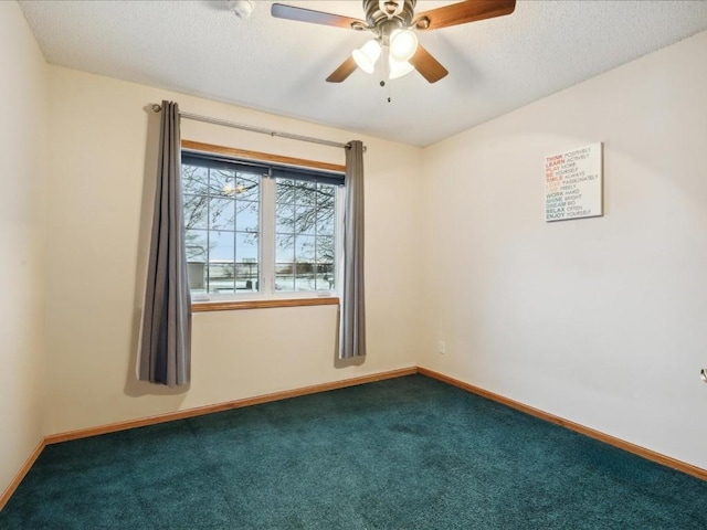 carpeted empty room with ceiling fan and a textured ceiling