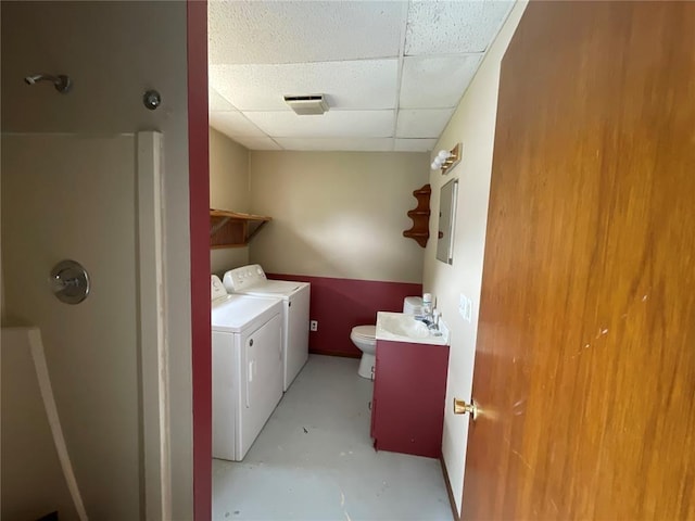 clothes washing area with electric panel, sink, and independent washer and dryer